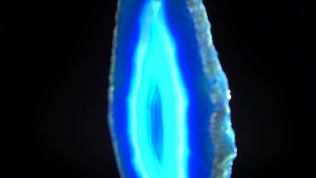 Seamlessly rotating dark blue mineral (Blue Agate) in front of black background