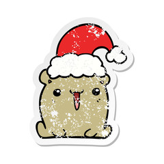 distressed sticker of a cute cartoon bear with christmas hat