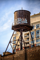 Old wood water tank with graffiti