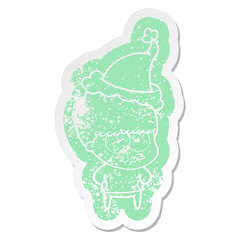 nervous cartoon distressed sticker of a boy wearing santa hat