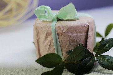 small present wrapped in paper and bowed silk ribbon