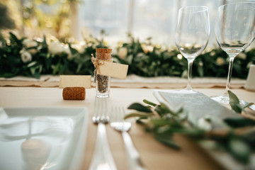 Details on decorated dining table in wedding reception hall.