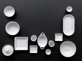 white, modern tableware in various designs on a black background