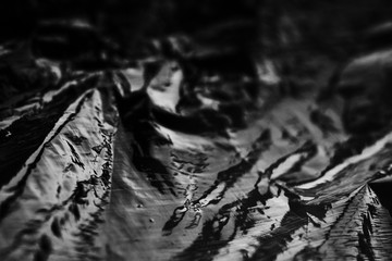 White and black abstract plastic package. Abstract reflections on the plastic surface  