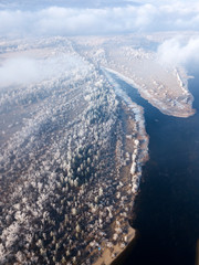 Aerial view of Volga river Bend and island with snowy trees in frost in Samara, Russia.