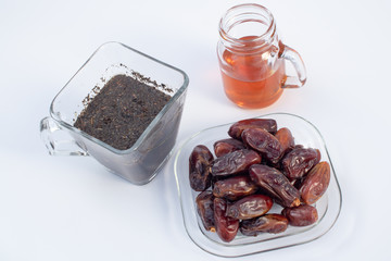 DATES IN GLASS PLATE WITH HOT TEA AND HONEY FOR IFTAR