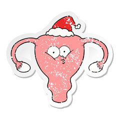 distressed sticker cartoon of a uterus wearing santa hat
