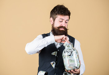 Businessman with his dollar savings. Richness and wellbeing. Security and money savings. Banking concept. Man bearded guy hold jar full of cash savings. Safe place to keep money. Personal accountant