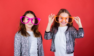 Obraz premium Sisterhood concept. Friendly relations siblings. Sincere cheerful kids share happiness and love. Girls funny big eyeglasses cheerful smile. Birthday party. Happy childhood. Joyful and cheerful