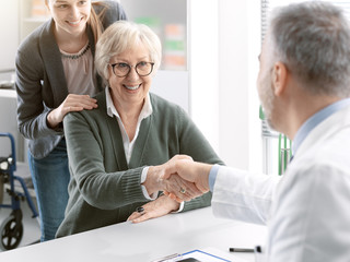 Doctor shaking hands with a senior patient