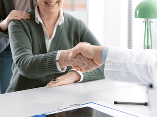 Doctor shaking hands with a senior patient