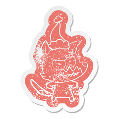 cartoon distressed sticker of a grinning fox wearing santa hat