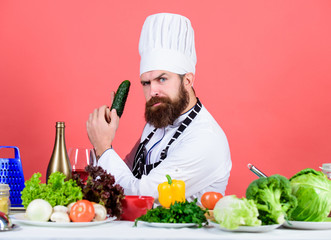 Interestedly sniffing it. Vegetarian. Mature chef with beard. Healthy food cooking. Bearded man cook in kitchen, culinary. Dieting and organic food, vitamin. Chef man in hat. Secret taste recipe