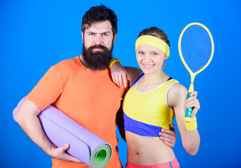 Victory and Success. Sporty couple training with fitness mat and tennis racket. Happy woman and bearded man workout in gym. Sport equipment. Strong muscles and body. ready for victory. sport success