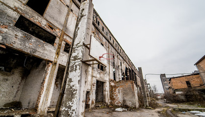 Fototapeta na wymiar Territory of abandoned industrial area waiting for demolition. Factory ruins.