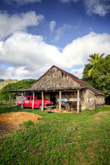 Fototapeta na wymiar Old barn with red retro car