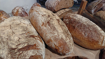 Baked rustic organic loaf bread on the counter in the bakery.