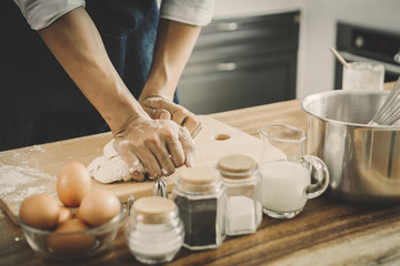 happy family in kitchen. Father and son knead dough and bake the bakery together