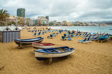 Fototapeta na wymiar Tourism and travel. Windy day on the ocean. Canary Islands, Gran Canaria, Atlantic Ocean. Tropics. Sandy beach in the city of Las Palmas