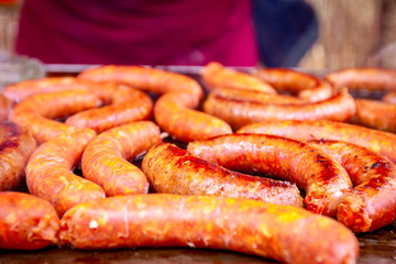 Fototapeta premium Baking delicious juicy sausages on barbecue plate