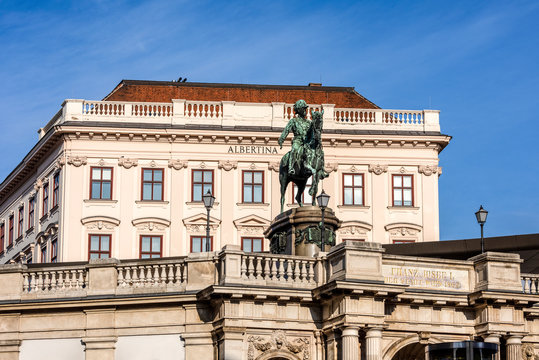 Austria, Vienna, Albrechtsplatz: Front view of world famous Albertina museum palais palace with Albrecht statue in the city center of the Austrian capital with blue sky - concept travel history art