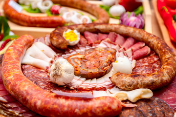 Traditional sausages are arranged with various smoked meat for review at food contest
