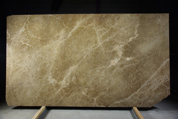 A large slab of natural marble from Italy brown in color with cracks and streaks is called Emperador Light