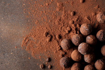 Fototapeta na wymiar assorted chocolates. candy balls of different types of chocolate on a dark background. cocoa and coffee beans. top view