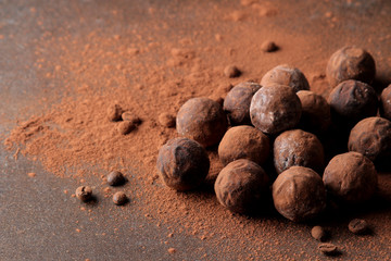 assorted chocolates. candy balls of different types of chocolate on a dark background. cocoa and coffee beans