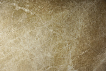 The beautiful background of natural marble from Italy is brown with cracks and streaks called Emperador Light