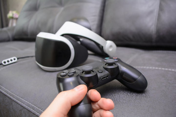 Helmet-glasses of virtual reality with a joystick. Virtual system . Electronics. Electronic headset. Virtual immersion. IT technology. Computer simulation and imitation.