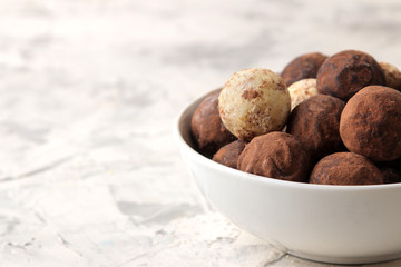 assorted chocolates. Candy balls of different types of chocolate on a light concrete background. free space