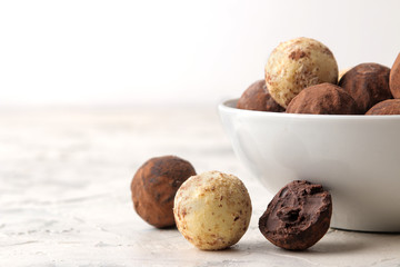 assorted chocolates. Candy balls of different types of chocolate on a light concrete background. free space