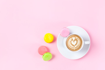 Cup of coffee and colorful macaroons
