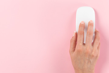 Person using computer mouse on pink background