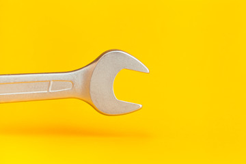 Wrench on yellow background
