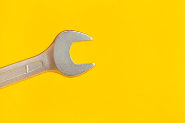 Wrench on yellow background