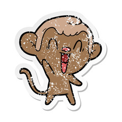 distressed sticker of a cartoon laughing monkey