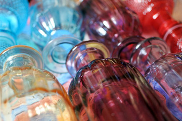 Background of ribbed colored glass flasks. coloured decorative glass 