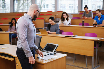 Lecturer and multinational group of students in an auditorium