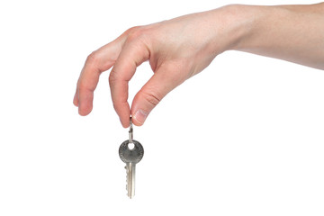 Human hand holding house key isolated on white background. Concept of new life and new home