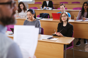 Lecturer and multinational group of students in an auditorium