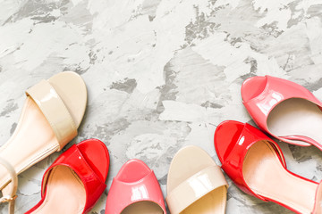 beautiful shoes and sandals on a gray background, a place for the text. Flat lay