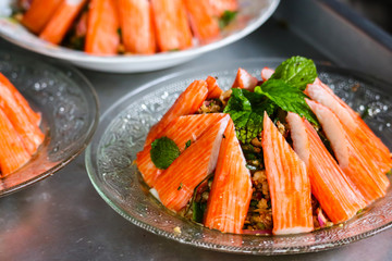spicy minced crab sticks salad and mint leaves on top