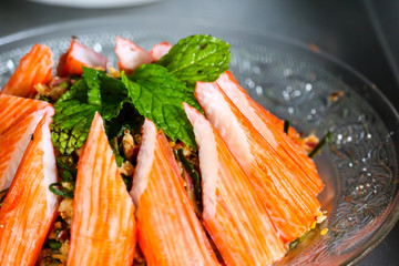spicy minced crab sticks salad and mint leaves on top