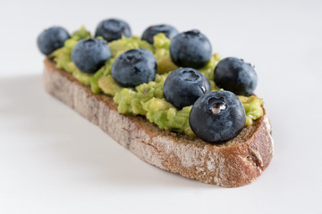 Fresh delicious homemade sandwich with blueberry and avocado.