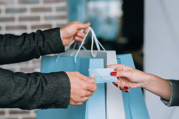 Urban shopping payment. Female lifestyle. Woman purchasing with credit card.