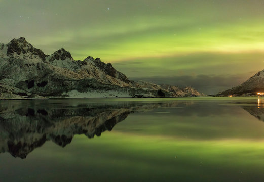 Eidsfjord  Mountain Range It reflects  in the water under a northern lights Holmstad, Sortland, Vester&aring;len, Norway,Europe