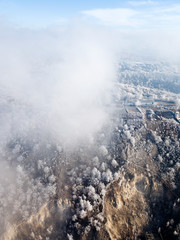 Aerial view of frost trees through the clouds, near Volga river, Samara, Russia.