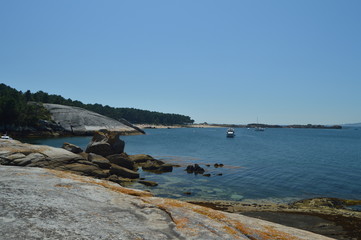 Boats Moored In The Estuary In Front Of The Horse Point Lighthouse On Arosa Island. Nature, Architecture, History, Travel. August 18, 2014. Isla De Arosa, Pontevedra, Galicia, Spain.